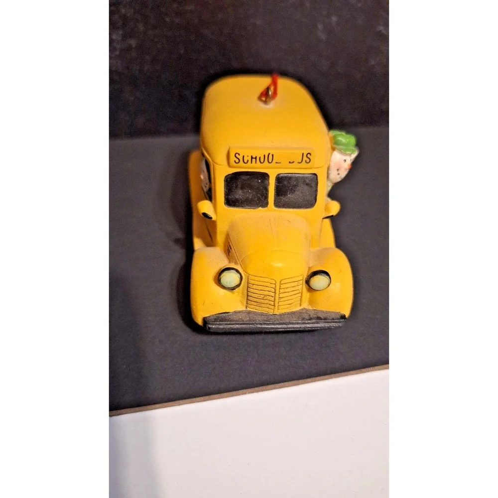 Resin school bus Christmas ornament with Santa and children